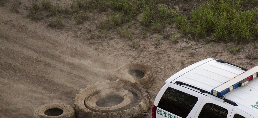A South Texas Border Patrol vehicle removes tracks in 2013.