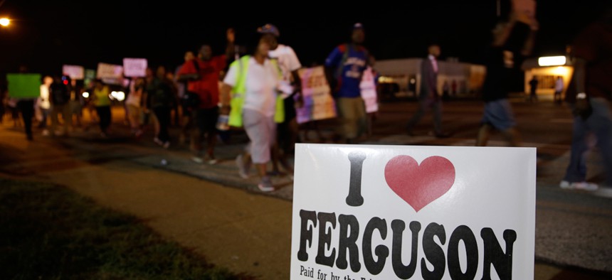 Protestors march Thursday in Ferguson.