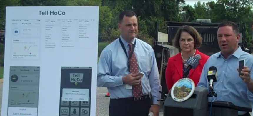 Howard County Executive Ken Ulman, at right, demonstrates the new Tell HoCo app.