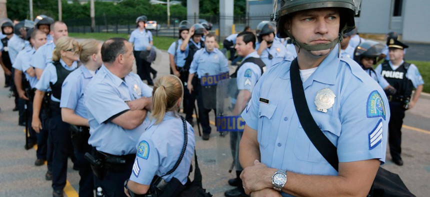 Police in riot gear prepare to take up positions during a protest in St. Louis in August.