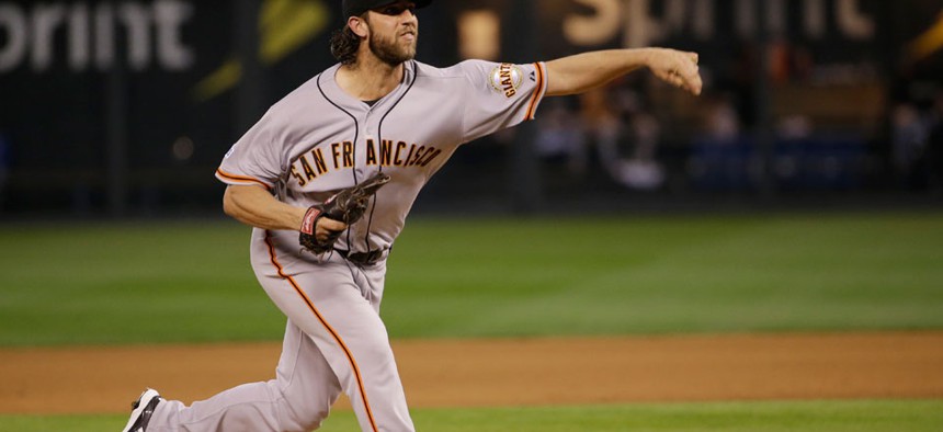 World Series MVP Madison Bumgarner pitches during the clinching World Series seventh game Thursday.