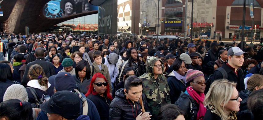 Commuters wait in a line to board buses into Manhattan in front of the Barclays Center in the Brooklyn borough of New York on Nov. 1, 2012.