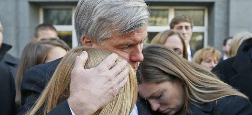 Former Virginia Gov. Bob McDonnell, center, hugs two of his daughters Cailin Young, left, and Jeanine McDonnell Zubowsky Tuesday in Richmond.