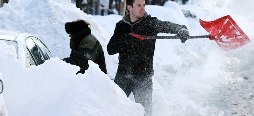 John Mensch shovels snow near Beacon Hill in Boston Tuesday.