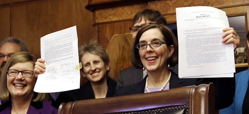 Oregon's new governor, Kate Brown, signed the automatic registration law on Monday.