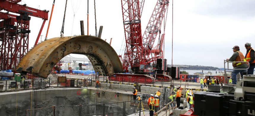 A crane lifts a 270-ton portion of "Bertha," the massive boring machine cutting a highway tunnel under Seattle.
