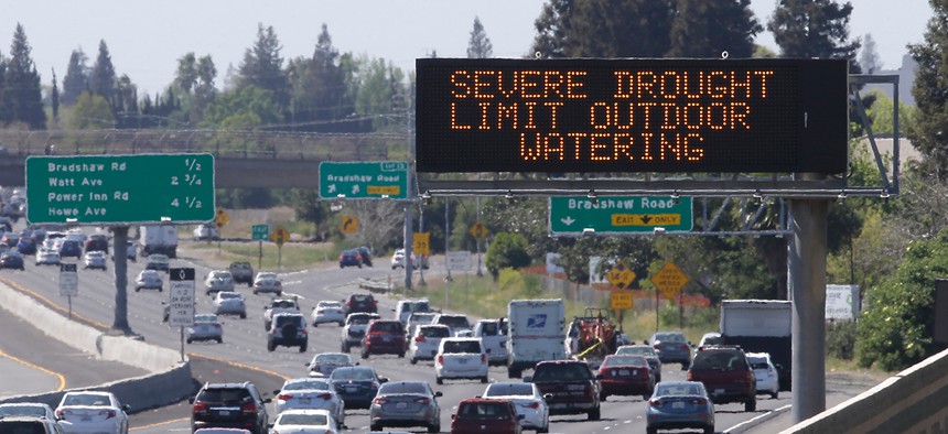 Motorists drive past a sign in Rancho Cordova Thursday.