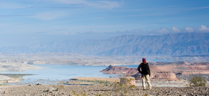 A backpacker looks out over Lake Mead in Nevada.