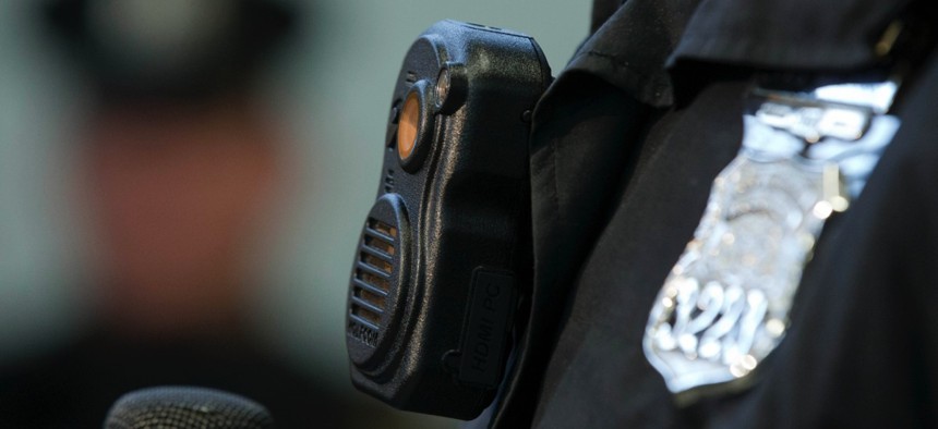 Philadelphia Police officers demonstrate a body-worn cameras being used as part of a pilot project in the department's 22nd District, Thursday, Dec. 11, 2014, in Philadelphia.