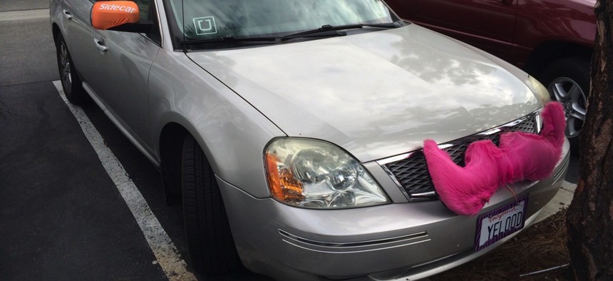 A car in use for three ridesharing companies: Uber, Lyft and Sidecar
