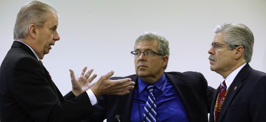 Illinois Auditor General William Holland, left, Illinois Rep. Frank J. Mautino, D-Spring Valley, center, and Illinois Rep. Fred Crespo, D-Steamwood, right, talk at the state Capitol on Tuesday, May 6, 2014, in Springfield, Ill.