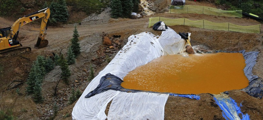Water flows through one in a series of retention ponds built to contain and filter out heavy metals and chemicals from the Gold King mine wastewater accident, in the spillway downstream from the mine outside Silverton, Colo., on Aug. 12, 2015.