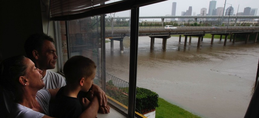 Stacy Stanley, Robert, and their 6-year-old son Zane watch the high water level on White Oak Drive at the Taylor Street underpass as floodwaters rise from the White Oak Bayou after heavy rains hit the Houston area on Saturday, April 18, 2009. The Stanley'