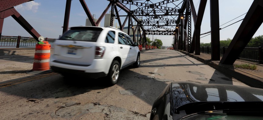 In this Sept. 11, 2013 file photo, vehicles drive on the 130th St. bridge over the Little Calumet River in Chicago that was classified as both "structurally deficient" and "fracture critical" in federal data for 2012.