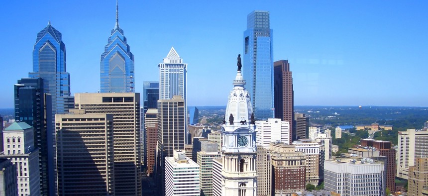 Comcast Center's tower, center right, rises behind the historic clocktower of Philadelphia City Hall.
