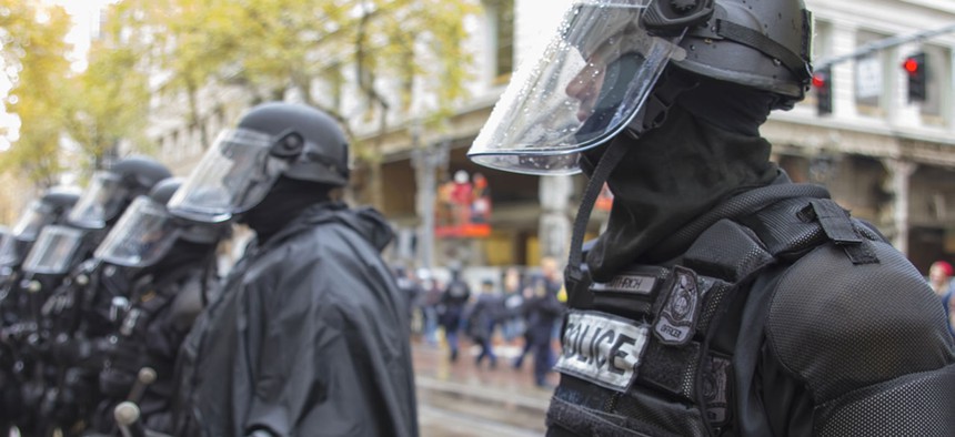 Police in riot gear stand in Portland during a protest in 2011.