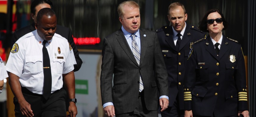 Seattle Mayor Ed Murray walks with Police Chief Kathleen O'Toole and Fire Chief Harold Scoggins at the scene of a fatal crash involving an amphibious tour vehicle and a charter bus in September.