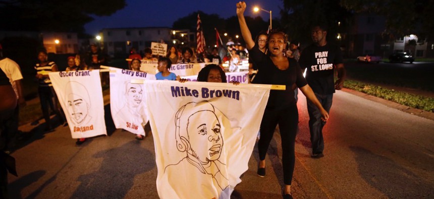 Protesters march down Canfield Drive in August near where Michael Brown was killed by a police officer in Ferguson, Missouri.
