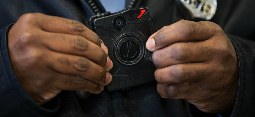 In this Dec. 11, 2014, file photo, a Philadelphia Police officer demonstrates a body-worn camera being used as part of a Philadelphia Police pilot project in the department's 22nd District