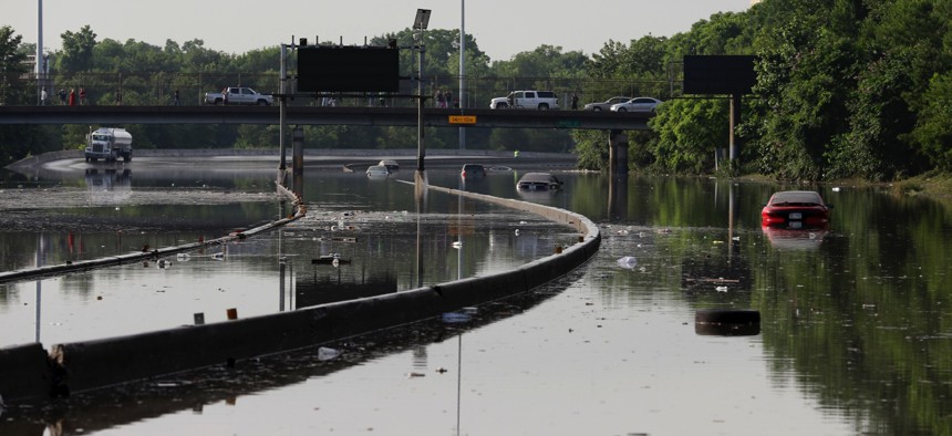 Cars remain stranded along a flooded section of Interstate 45 after heavy rains overnight in Houston, Tuesday, May 26, 2015. 