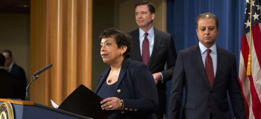 Attorney General Loretta Lynch, accompanied U.S. Attorney Preet Bharara of the Southern District of New York, right, and FBI Director James Comey, arrives to a news conference at the Justice Department in Washington, Thursday, March 24, 2016.