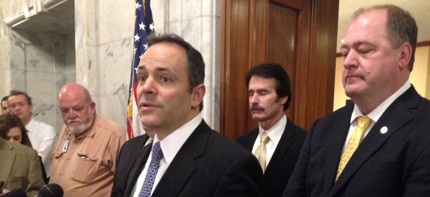 Republican Gov. Matt Bevin speaks with reporters about the status of Kentucky's budget negotiations as House Minority Whip Stan Lee and House Minority Floor Leader Jeff Hoover listen, on Tuesday, March 29, 2016 in Frankfort, Ky.