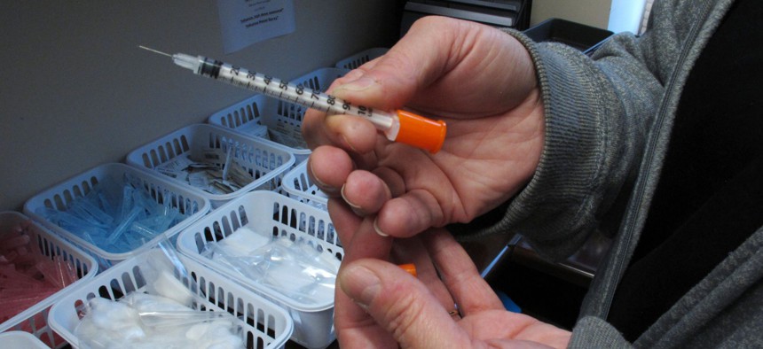Paula Maupin, the public health nurse for eastern Indiana's Fayette County, holds one of the syringes provided to intravenous drug users taking part in the county's state-approved needle exchange program, which is housed in the county courthouse in Conner