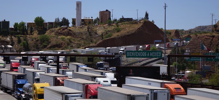 Trucks carry goods and possibly contraband north into Nogales, Arizona.