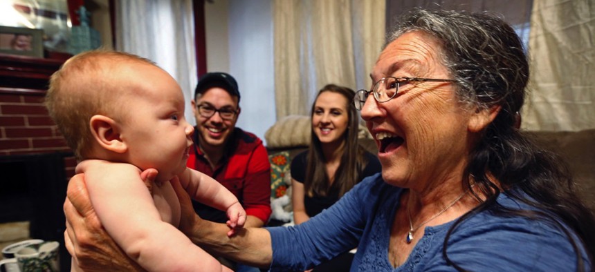 Jill Breen, a midwife, examines 10-week-old Maggie Dickson while her parents Jamie and Shannon Dickson look on, at their home in Waterville, Maine.