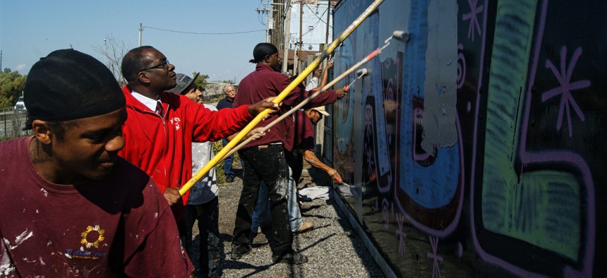 Mayor Byron Brown joins citizen volunteers to clean up graffiti in Buffalo, New York.