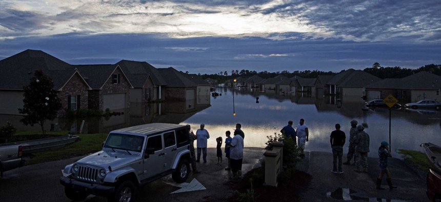 esidents line up on Providence Boulevard in Hammond, La., where flood waters inundated their homes after heavy rains in the region Saturday, Aug. 13, 2016.