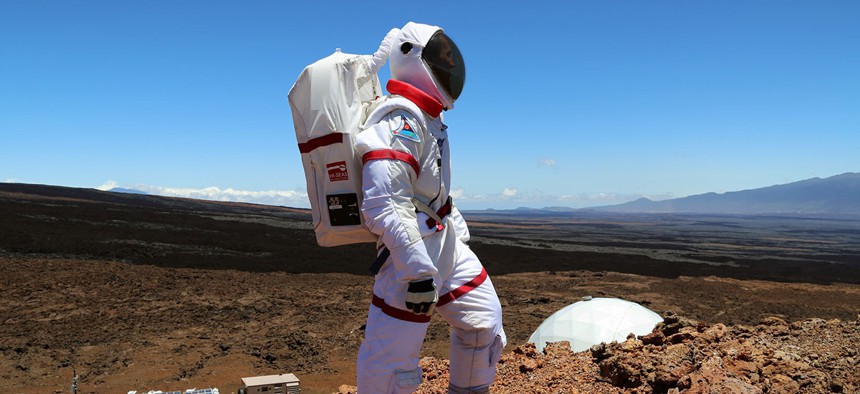 A HI-SEAS crew member from a previous mission explores 'Mars' in Hawaii.