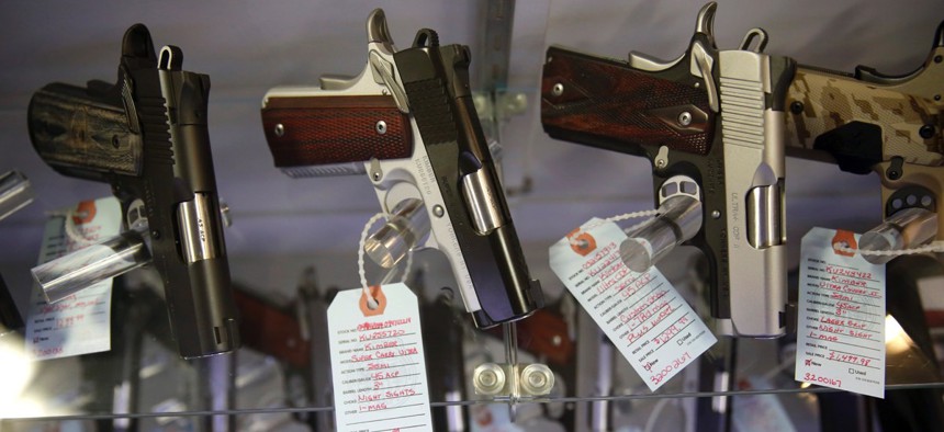 Handguns in a display case at Metro Shooting Supplies, in Bridgeton, Mo.