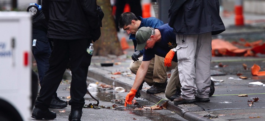Evidence teams investigate the scene of Saturday's explosion in Manhattan's Chelsea neighborhood.