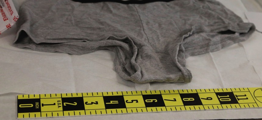 A pair of panties from a sexual assault evidence kit are measured before testing for semen.