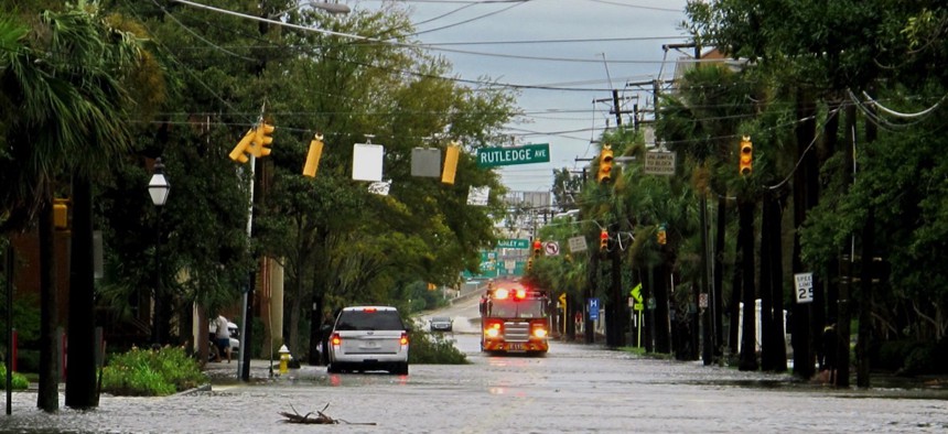 A firetruck drives through a flooded street in the hospital district of Charleston, S.C. on Saturday