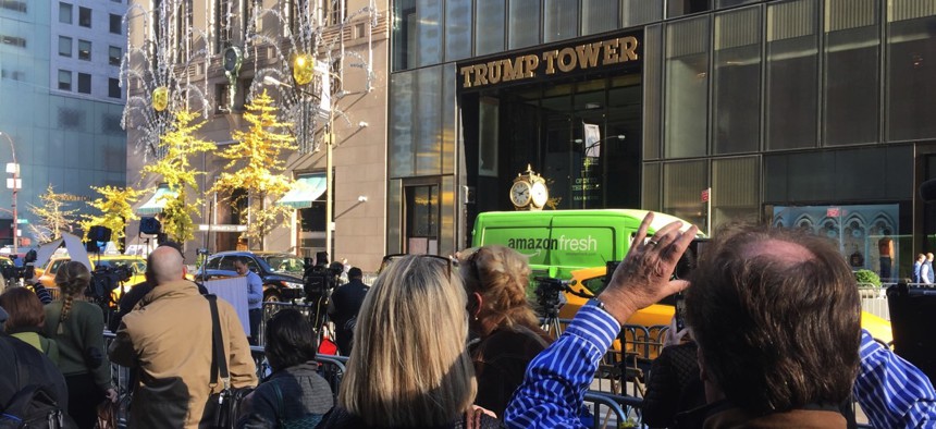 Tourists and pedestrians in front of heightened security at the entrance to Trump Tower in New York City.