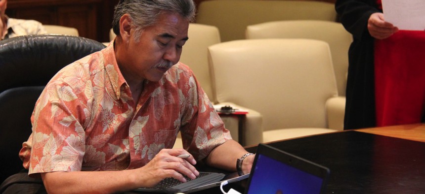 Hawaii Gov. David Ige e-signing a document.