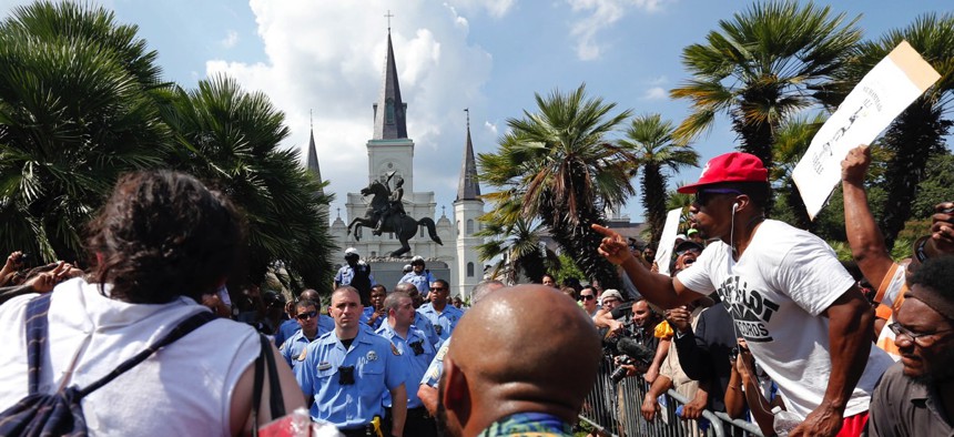 New Orleans police guard a statue of Andrew Jackson, in Jackson Square, during a protest organized by Take 'Em Down NOLA on Sept. 24.