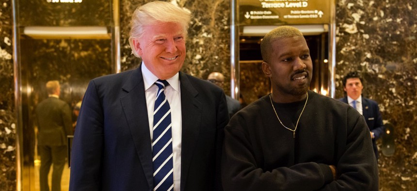 President-elect Donald Trump, left, and Kanye West pose for a picture in the lobby of Trump Tower in New York, Tuesday, Dec. 13, 2016.