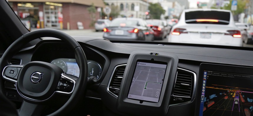 an Uber driverless car waits in traffic during a test drive in San Francisco.