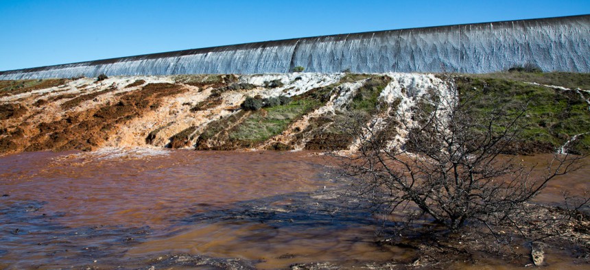 Water flows over the auxiliary spillway at the Oroville Dam in Northern California on Saturday.