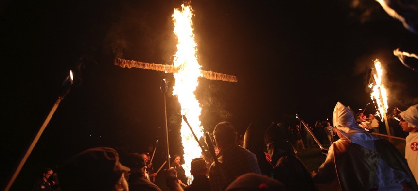 members of the Ku Klux Klan participate in cross burnings after a "White Pride," rally, in rural Paulding County near Cedar Town, Ga. in 2016.