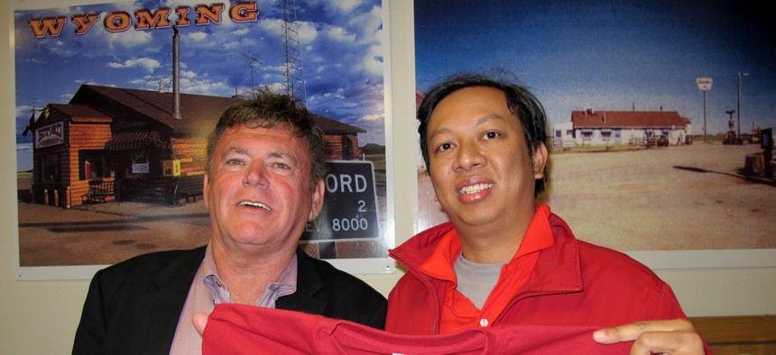 Vietnamese businessman Nguyen Dinh Pham, right, poses with Don Sammons, the self-proclaimed "mayor" of Buford, Wyoming, after winning the auction for the town in 2012.