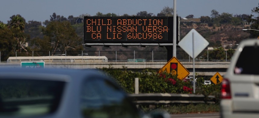 Drivers pass a display showing an Amber Alert, asking motorists to be on the lookout for a specific vehicle, on Aug. 6, 2013, in San Diego.