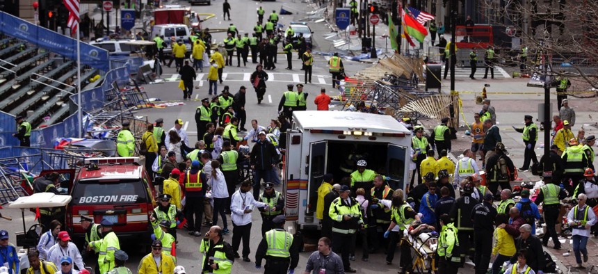 Medical workers aid injured people following the explosion at the finish line of the 2013 Boston Marathon.