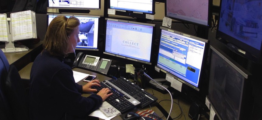 Dispatcher Kelly Orsini at her communications desk at the Naugatuck, Connecticut, Police Department.