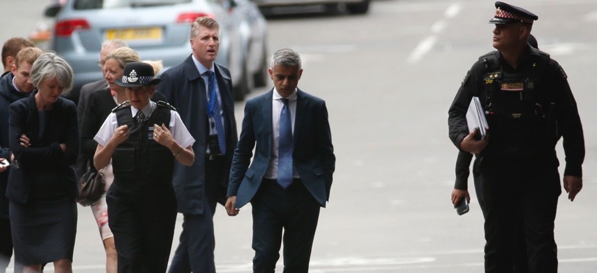 Mayor of London Sadiq Khan, center, arrives at the London Bridge area of London on Monday ahead of a vigil for victims of a presumed terrorist attack.