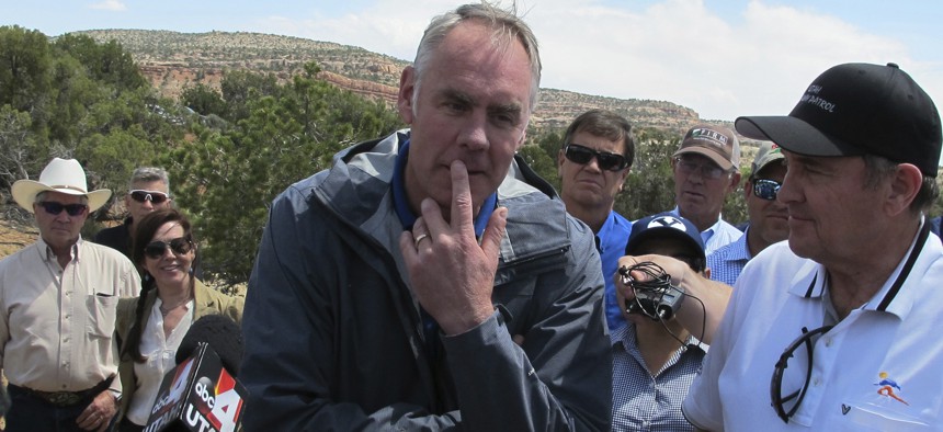 Interior Secretary Ryan Zinke, center, is joined by Utah Gov. Gary Herbert, right, during a press conference Monday, May 8, 2017, at the Butler Wash trailhead within Bears Ears National Monument near Blanding, Utah.