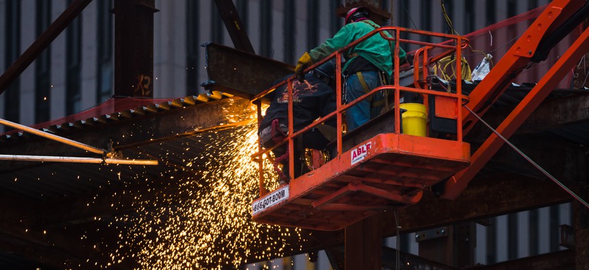 orkers on the construction site. Metal welding work at the construction site in Lower Manhattan. Sparks from welding work.